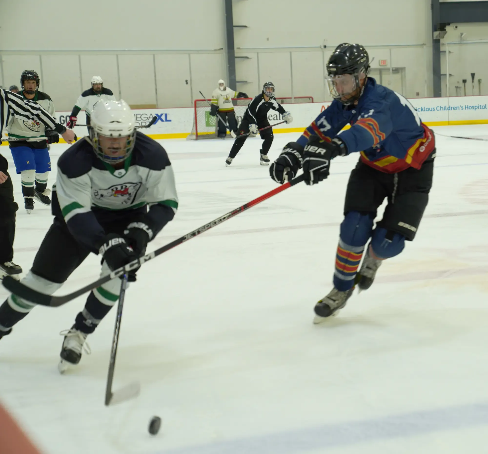 A Whiskey Dekes player chasing the puck on home ice